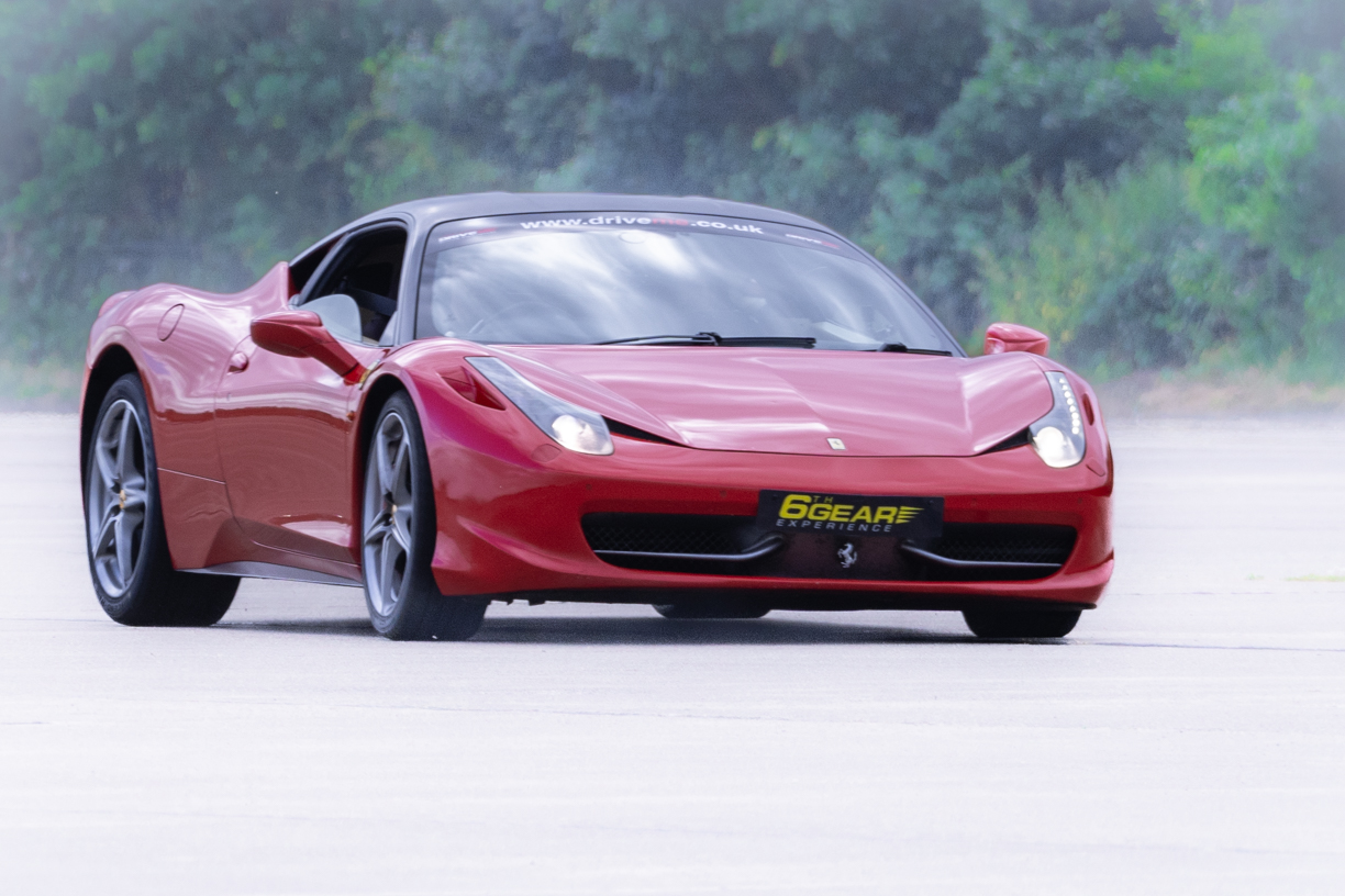 a Ferrari 457 driving around a race track for 6th Gear Experience