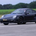 a Porsche driving around a racetrack for 6th Gear Experience